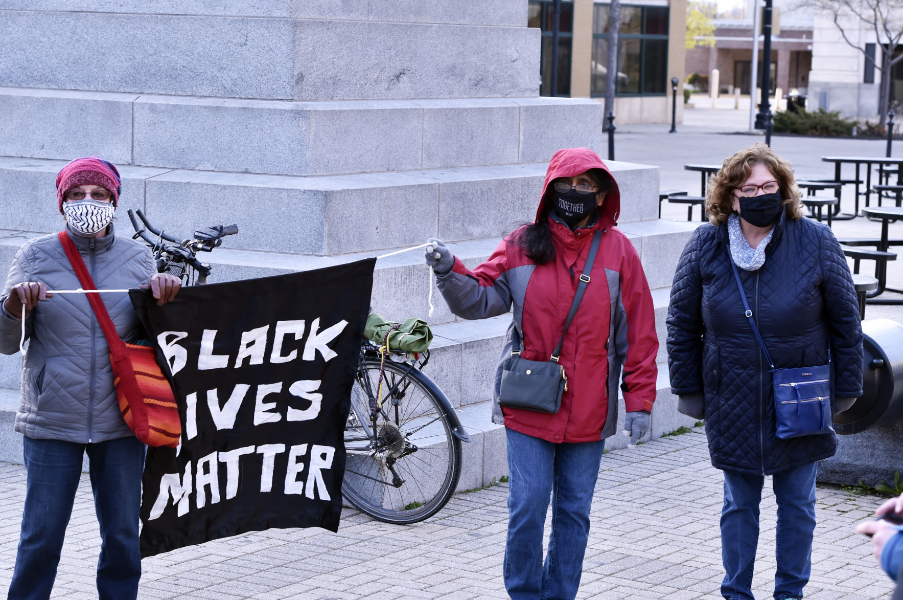 Carrying a Black Lives Matter flag on Monument Square after Derek Chauvin is convicted in the killing of George Floyd